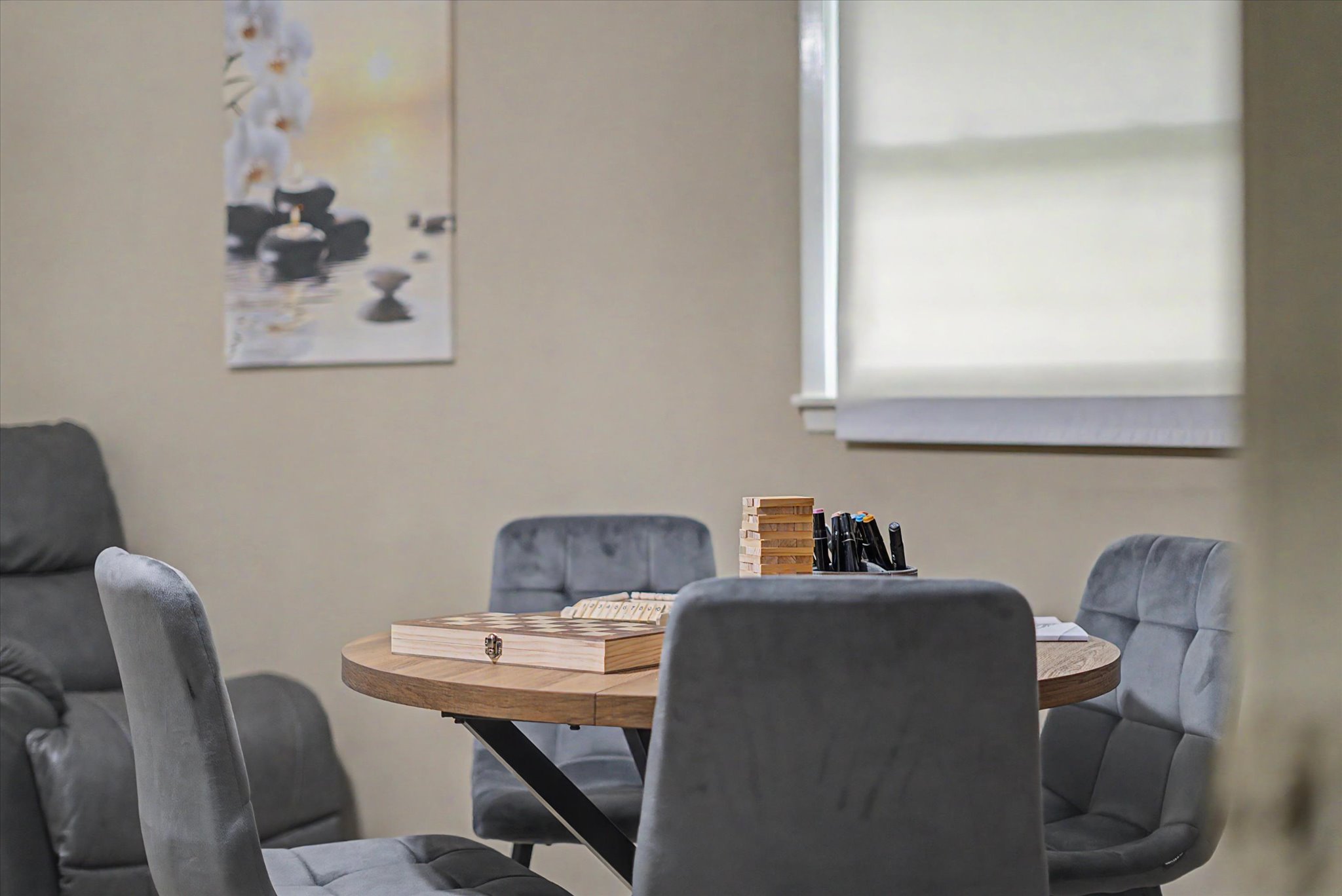 A warm portrait of a smiling elderly woman in a cozy living room setting at VitalNest Living